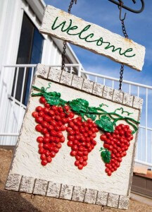 Welcome sign with grapes on a vine