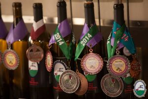 wine bottles with award medals around them